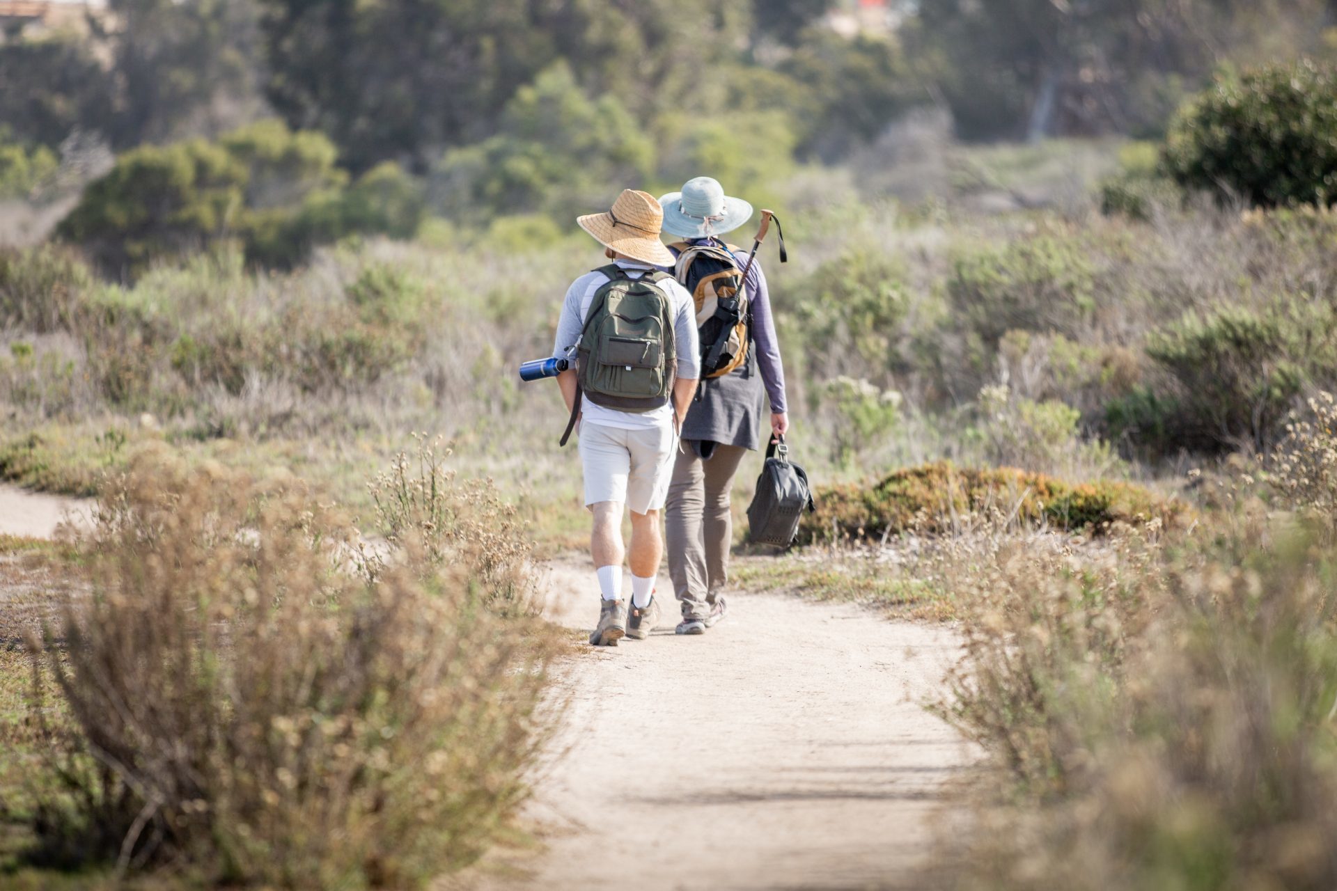 Two people walking along a nature trail