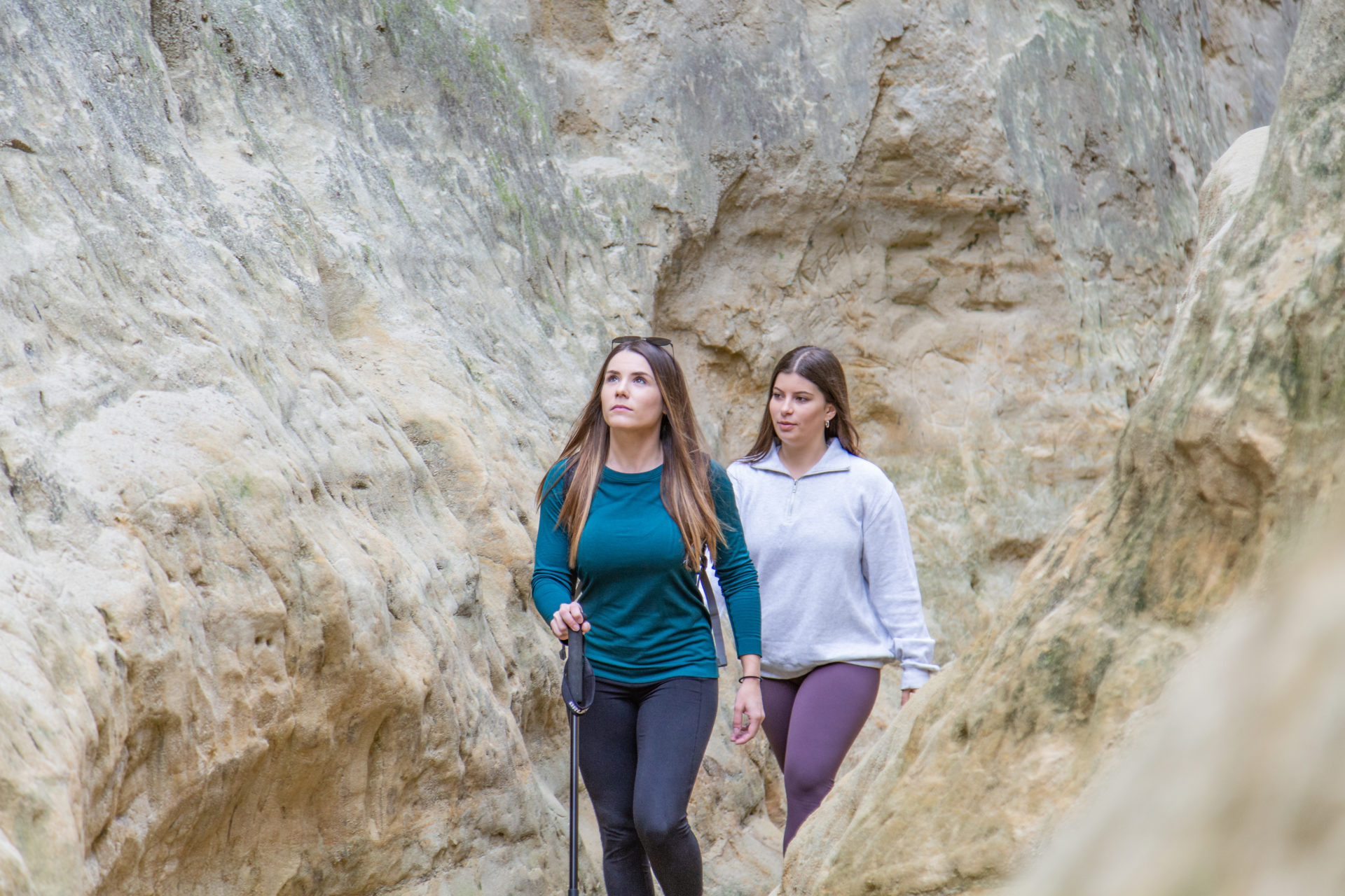 2 women hike the slot canyon at Annie's Canyon Trail in San Elijo Lagoon
