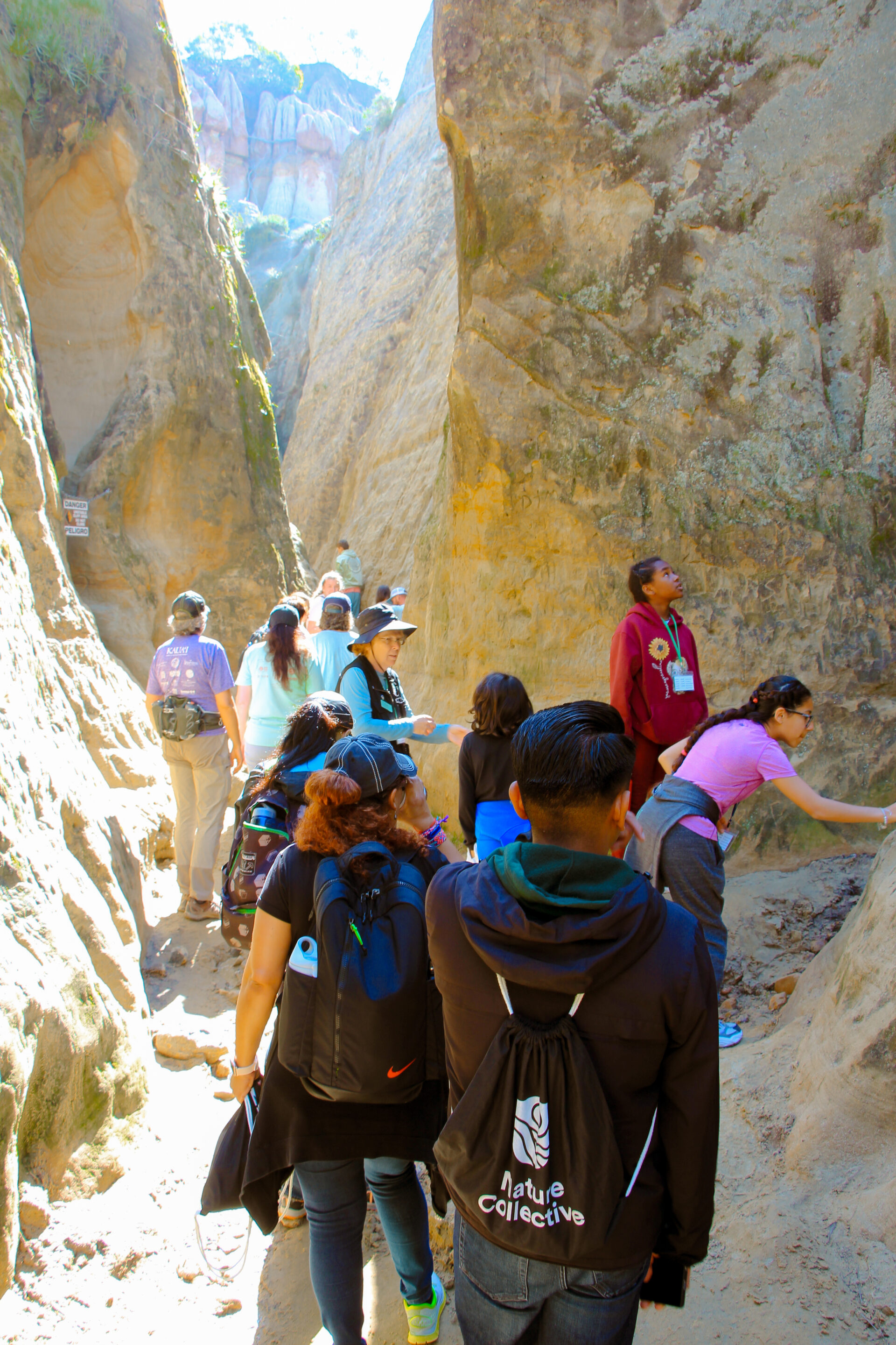 Group of children hiking through a slot canyon