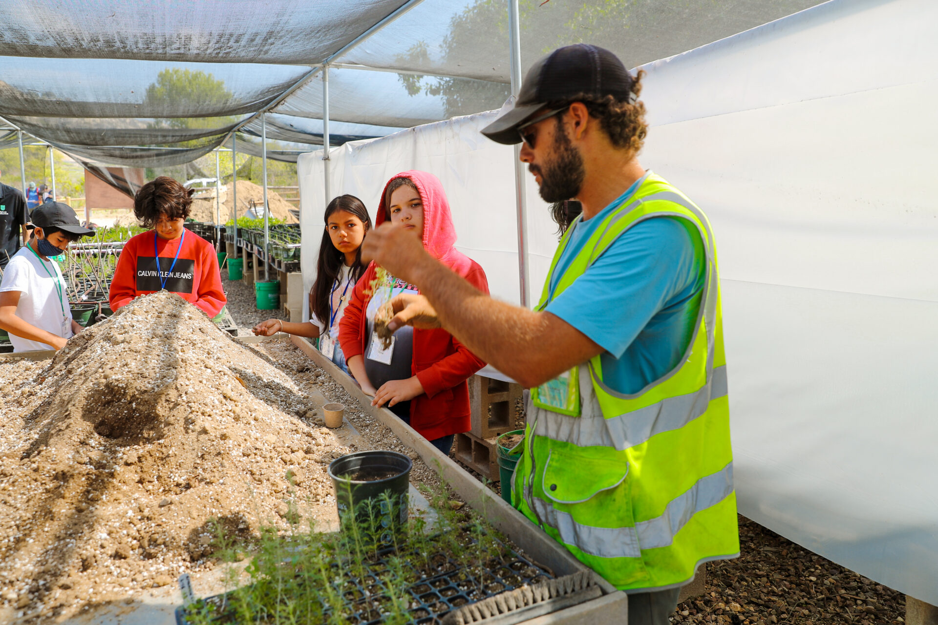 Children watching a planting demonstration