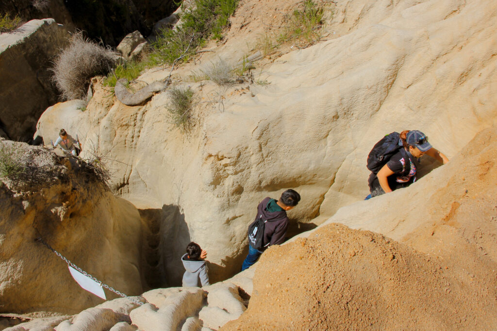 Students hiking through a slot canyon