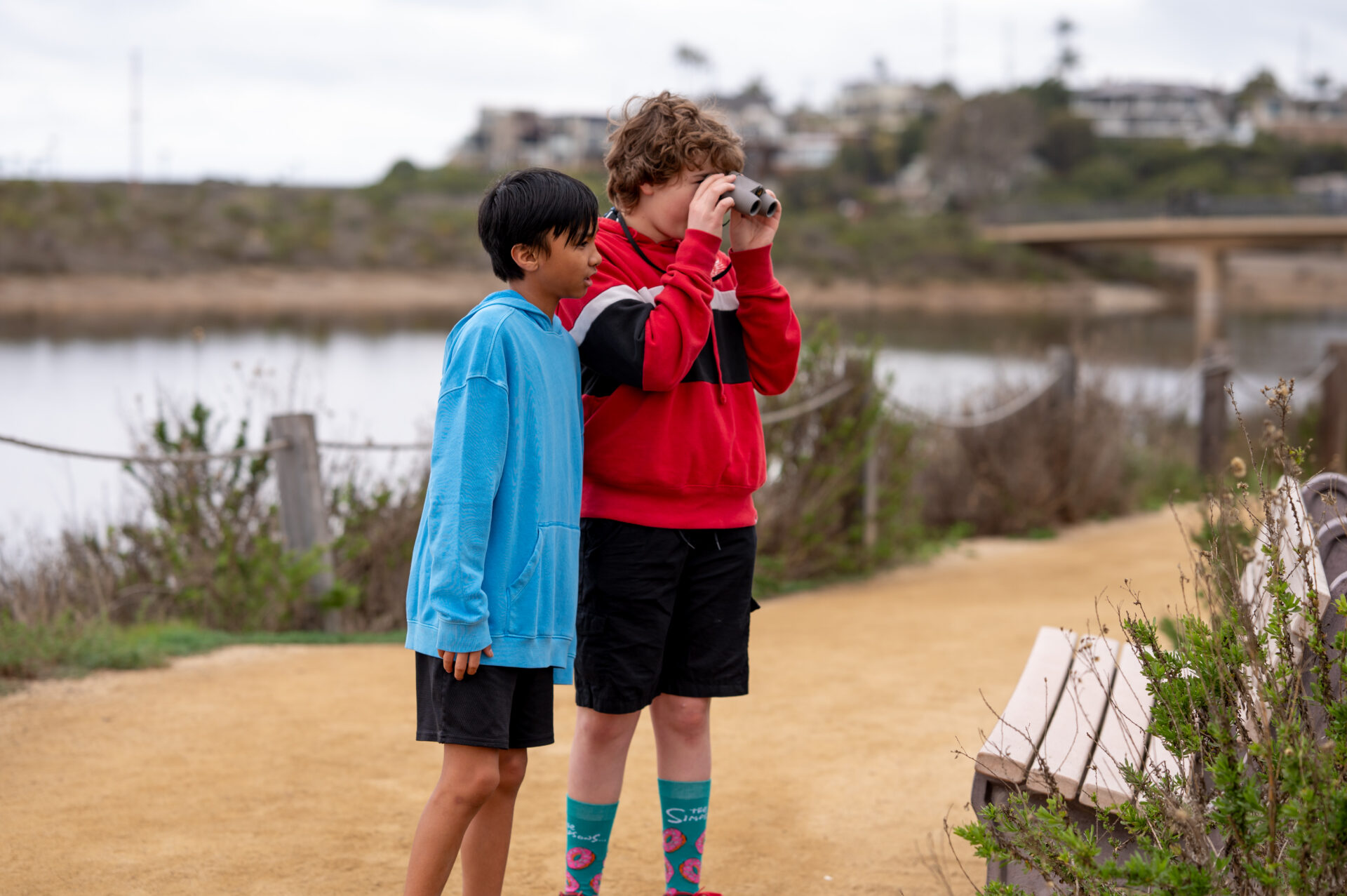 Two middle school kids at Nature Center looking at wildlife