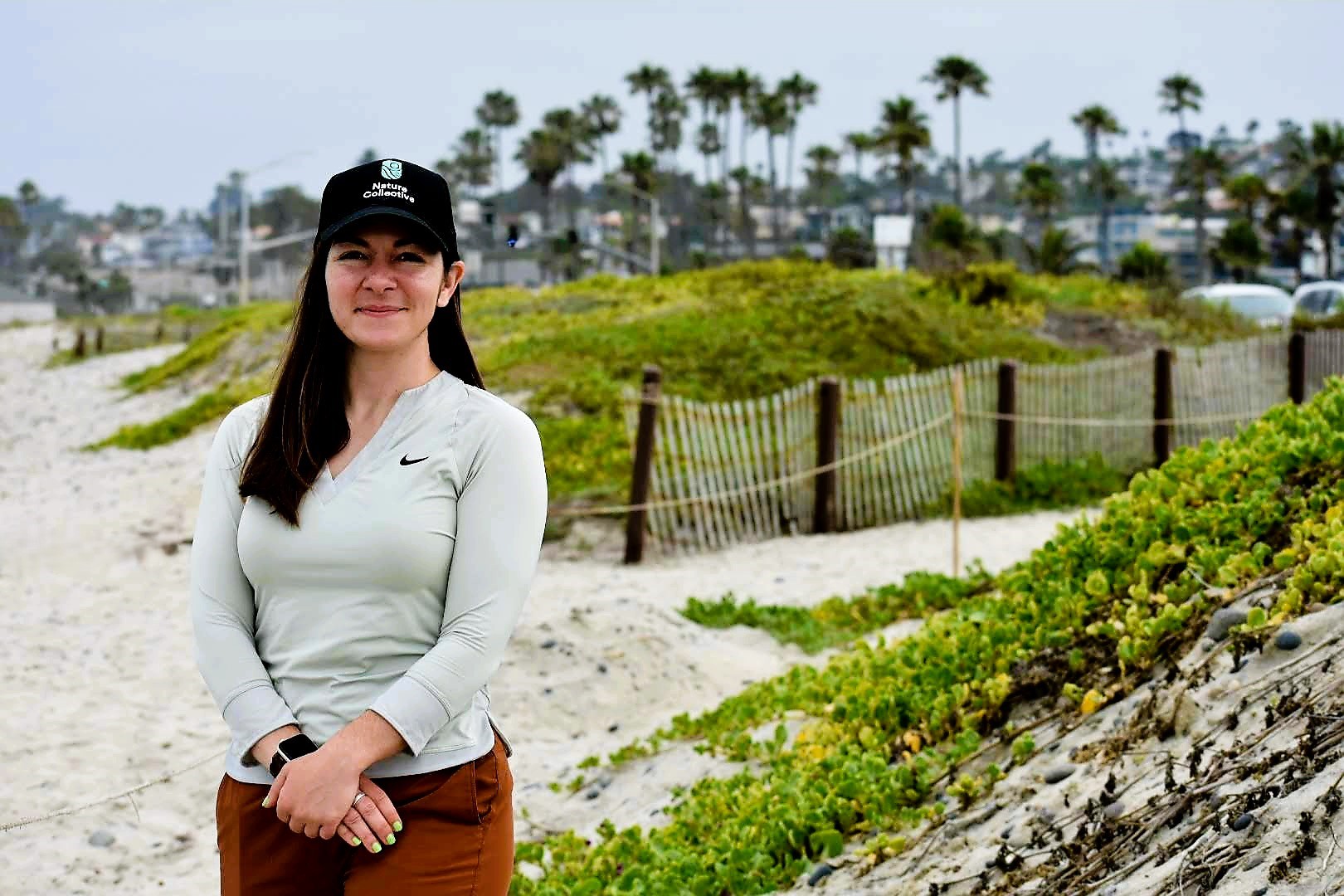 Photo of Kindra Hixon standing in front of sand dune