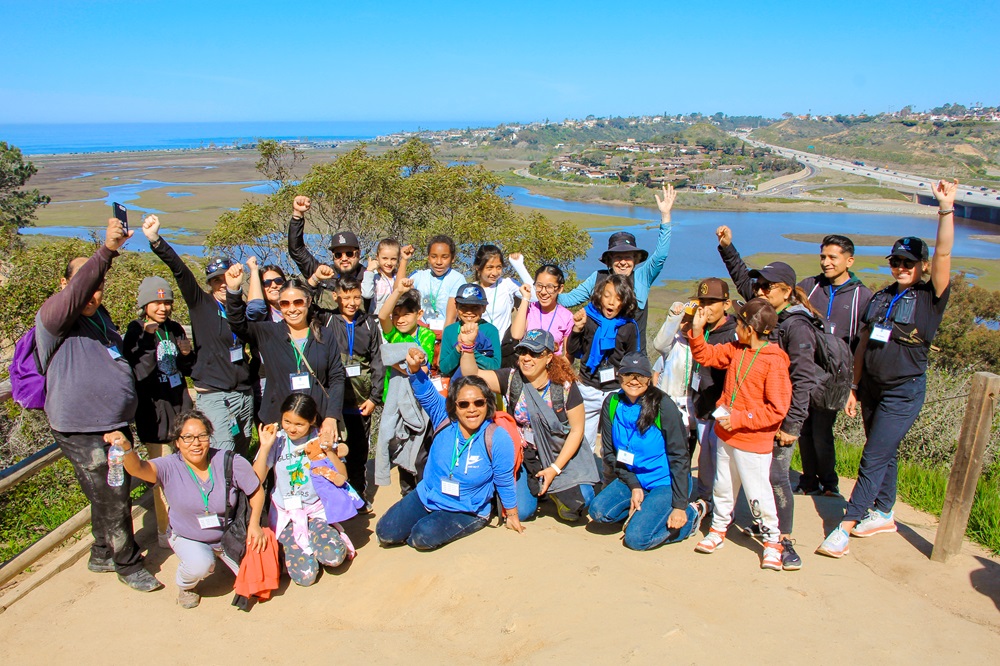 Group of GOING program students and parents excited at the top of Annie's Canyon Trail