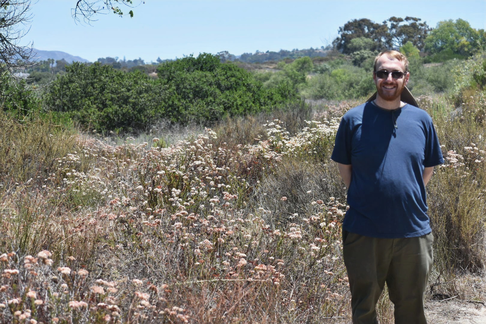 Johua Rey with native vegetation in the background