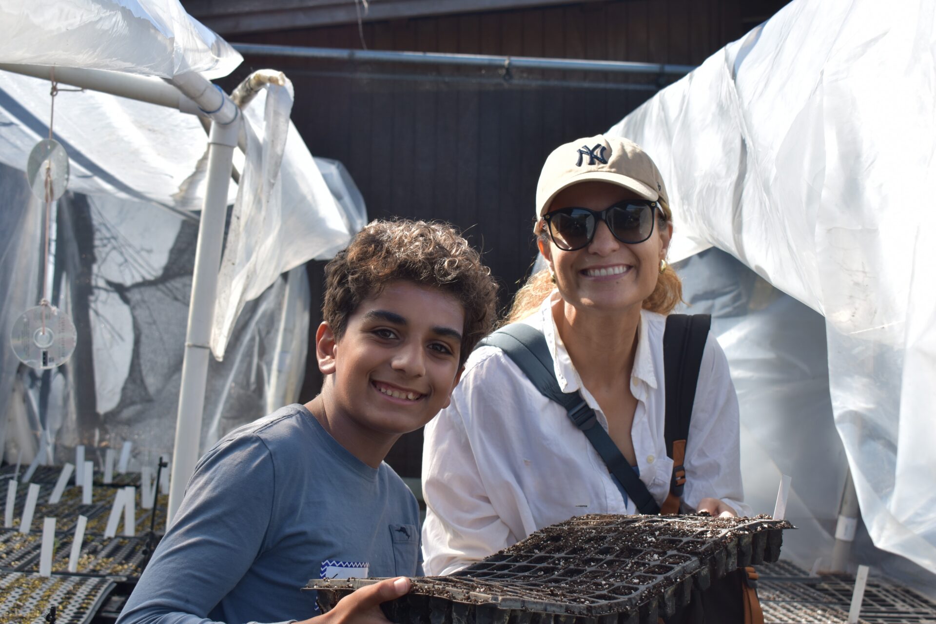 Student and parent show a tray of seeds they planted together
